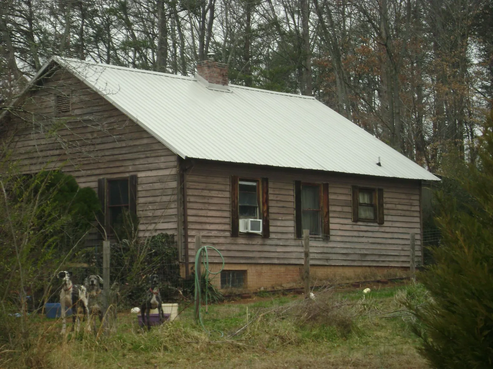 White metal roof on an old wood sided farmhouse, from a Metal Roof Installation job in Sterrett